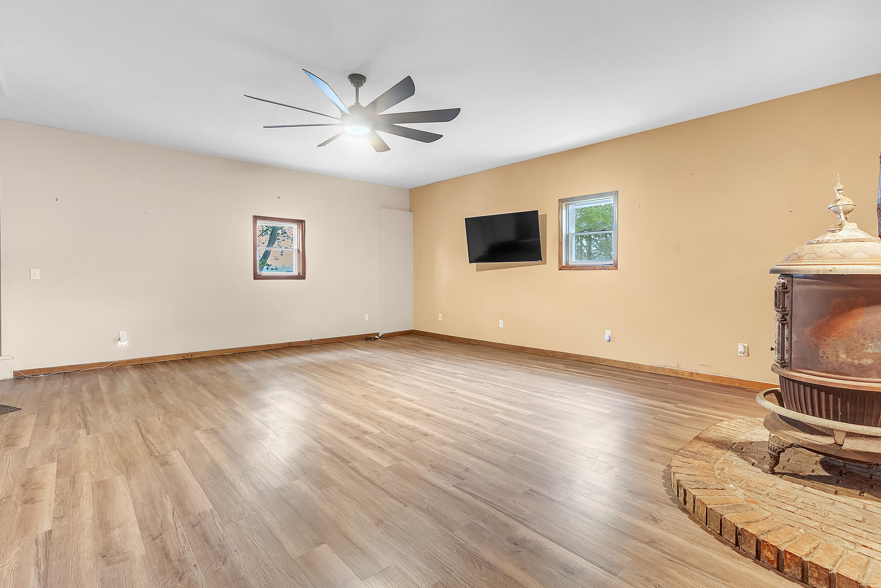 2204 South Meridian Road Morocco, IN 47963 - Photo 4 of 35 a view of empty room with wooden floor and fan