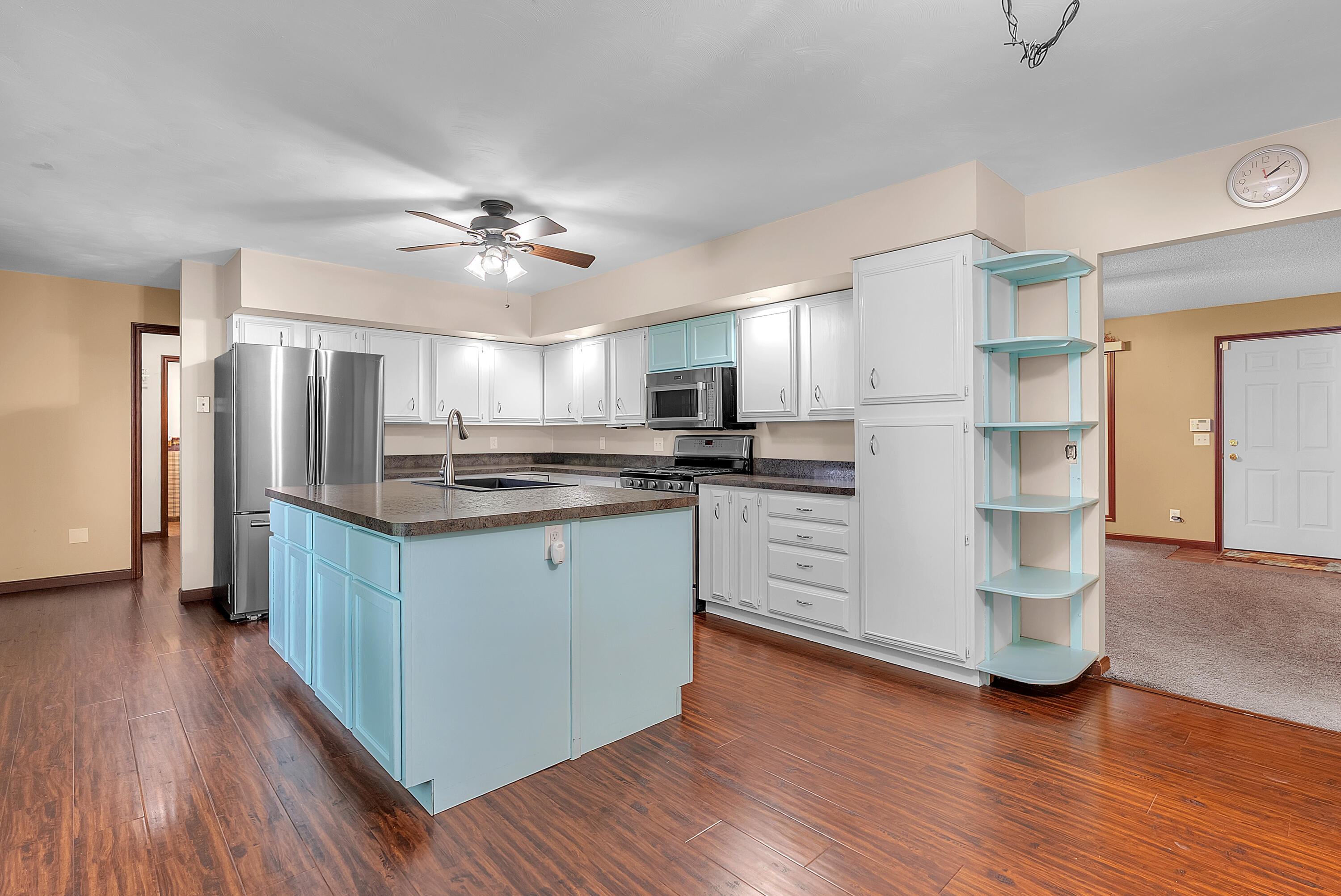2204 South Meridian Road Morocco, IN 47963 - Photo 10 of 35 a kitchen with kitchen island wooden floors appliances and cabinets