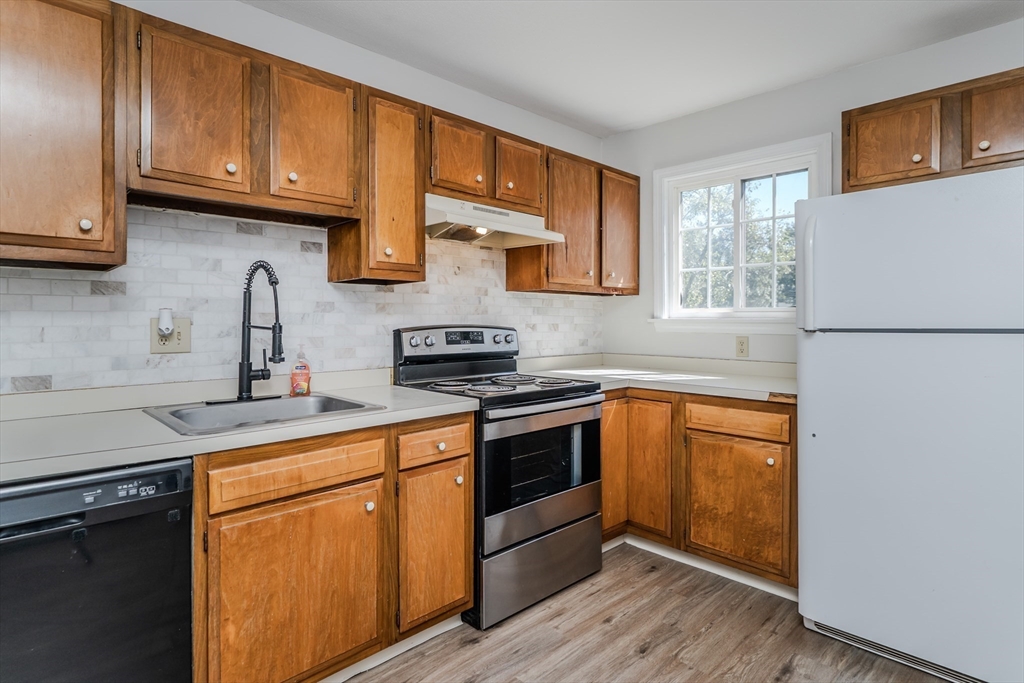 170 East Hadley Road, Unit 46 Amherst, MA 01002 - Photo 12 of 31 a kitchen with stainless steel appliances granite countertop a sink stove and refrigerator