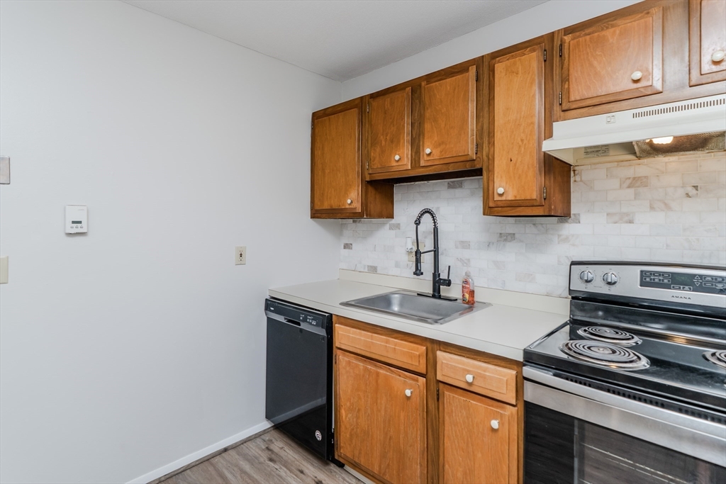 170 East Hadley Road, Unit 46 Amherst, MA 01002 - Photo 14 of 31 a kitchen with stainless steel appliances granite countertop a sink stove and cabinets