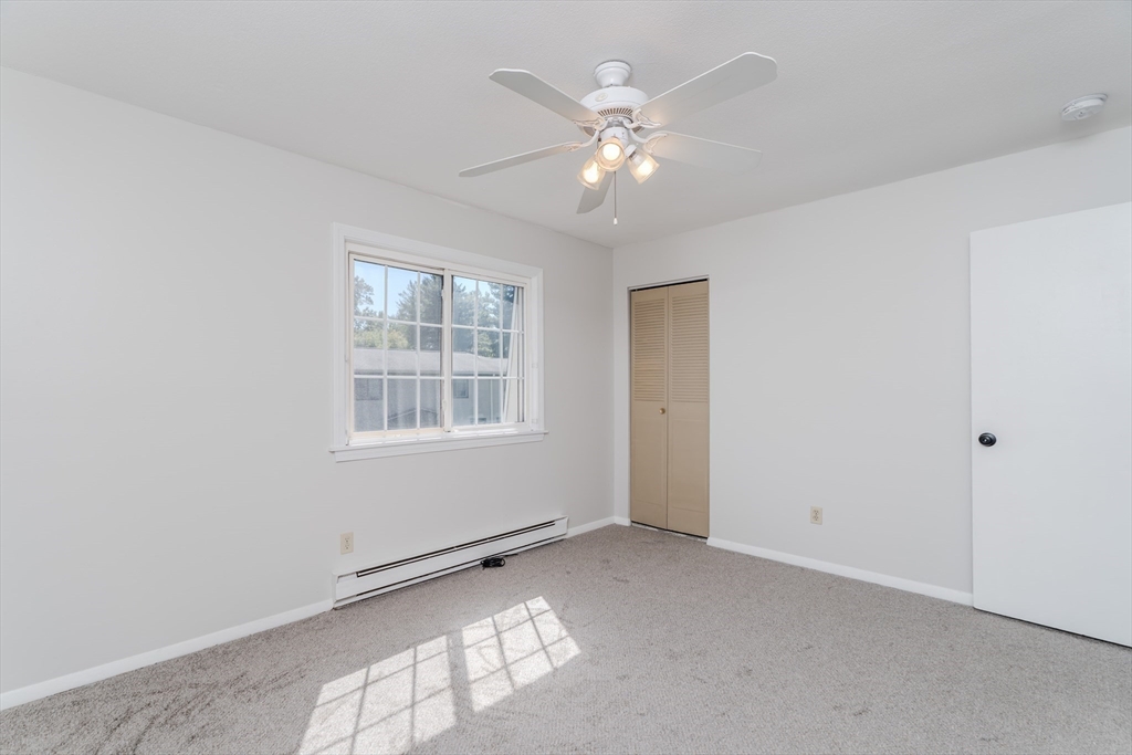 170 East Hadley Road, Unit 46 Amherst, MA 01002 - Photo 19 of 31 a view of an empty room with a window