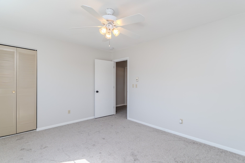 170 East Hadley Road, Unit 46 Amherst, MA 01002 - Photo 20 of 31 a view of an empty room with a chandelier fan