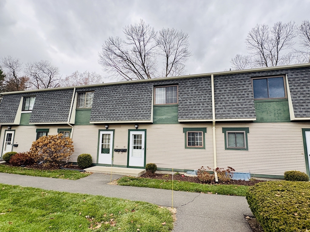 170 East Hadley Road, Unit 46 Amherst, MA 01002 - Photo 3 of 31 a front view of a house with a yard and garage