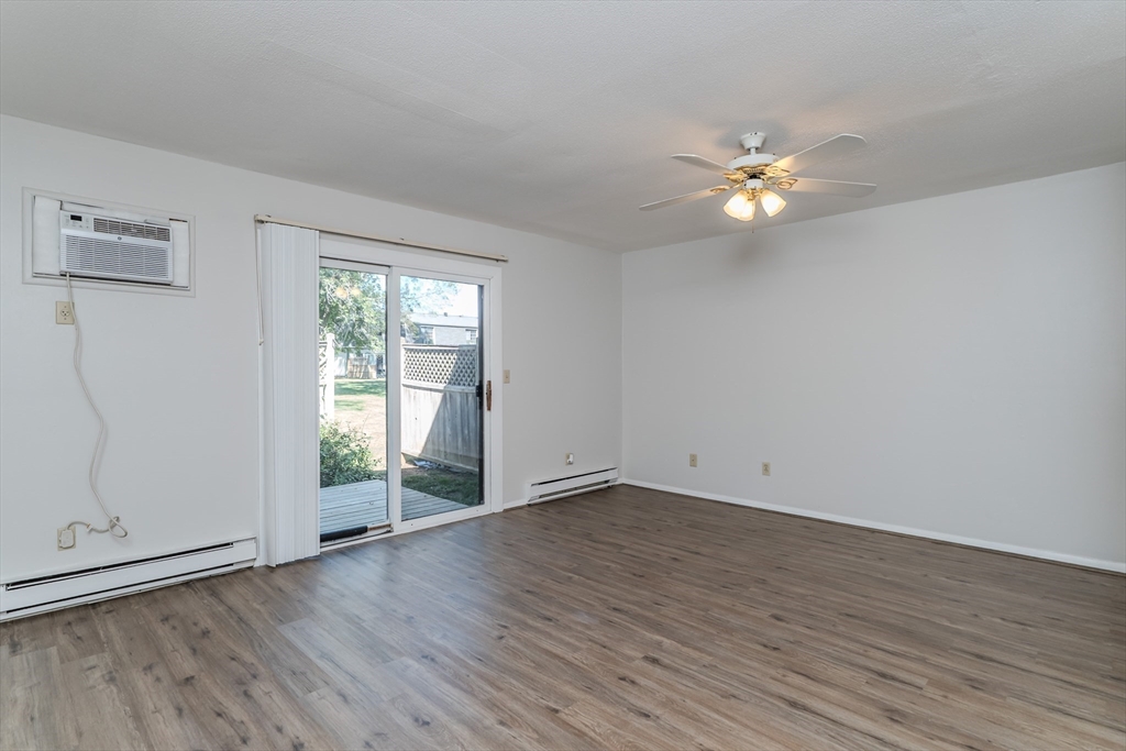 170 East Hadley Road, Unit 46 Amherst, MA 01002 - Photo 10 of 31 an empty room with wooden floor and window
