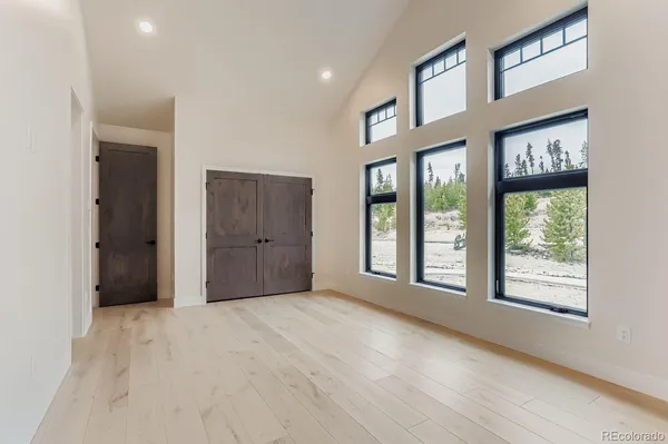 a view of an empty room with kitchen island granite countertop a fireplace