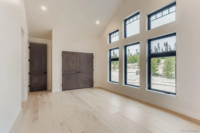 a view of an empty room with kitchen island granite countertop a fireplace