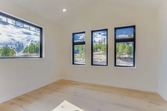 a living room with stainless steel appliances kitchen island granite countertop a couch and a view of kitchen