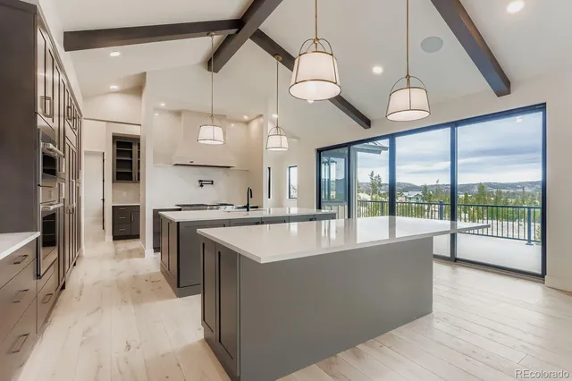 an empty room with wooden floor and a fireplace