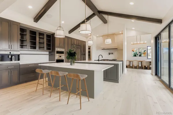 a view of an empty room with a window and chandelier