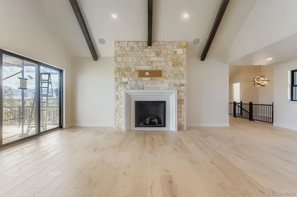 a view of an empty room and fire place