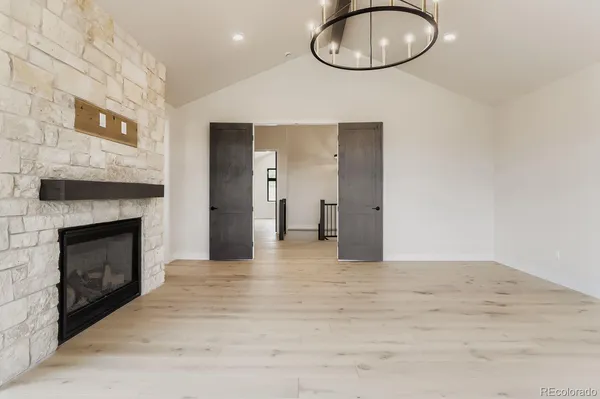 a bedroom with a large bed and a fireplace