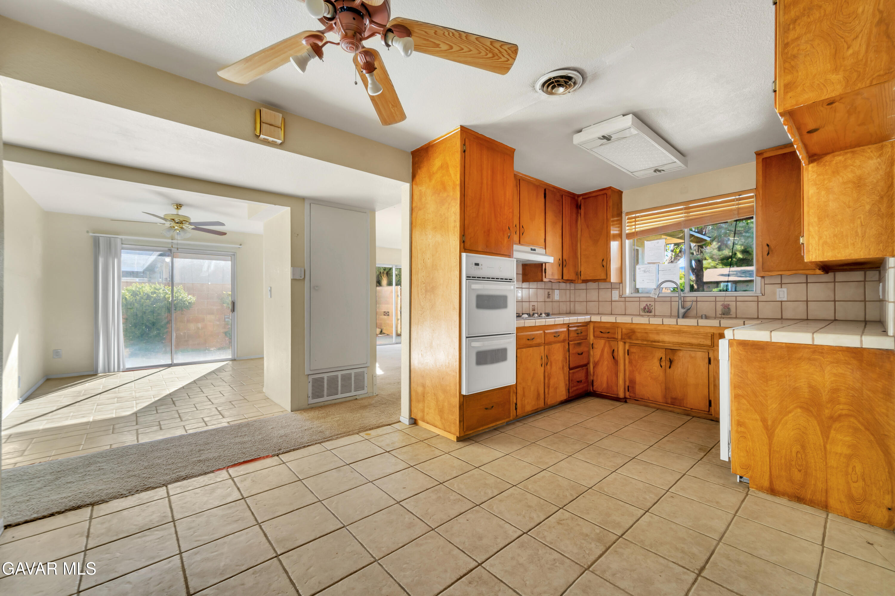 41522 Rimfield Avenue Lancaster, CA 93536 - Photo 3 of 15 a kitchen with a refrigerator a sink and a stove top oven