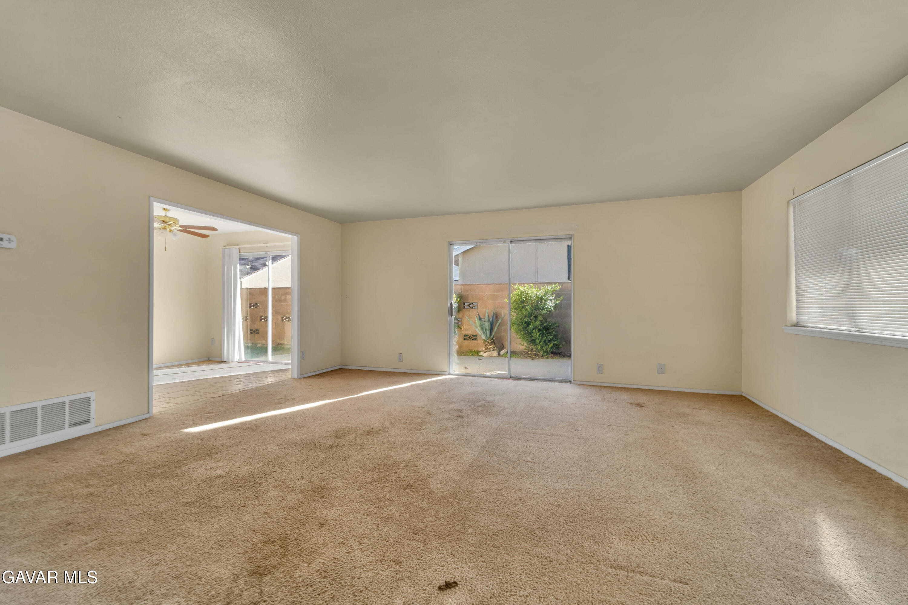 41522 Rimfield Avenue Lancaster, CA 93536 - Photo 5 of 15 a view of a big room with windows and chandelier fan
