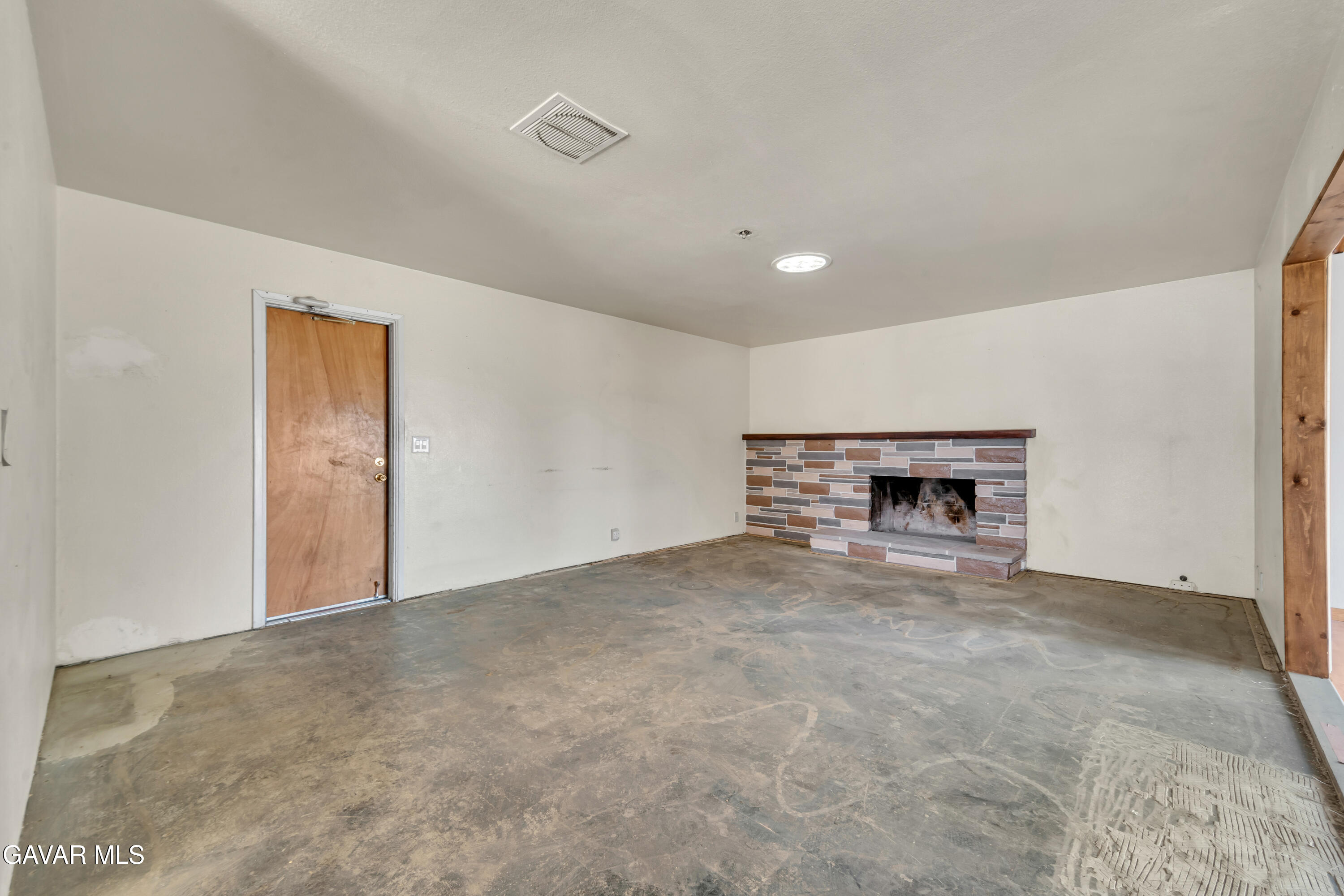 41522 Rimfield Avenue Lancaster, CA 93536 - Photo 7 of 15 a view of an empty room with a fireplace