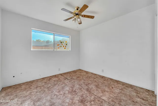 an empty room with table and fan