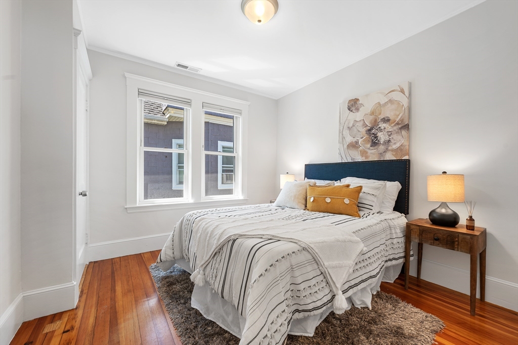 24 Jackson Road, Unit 2 Somerville, MA 02145 - Photo 20 of 35 a bedroom with a bed and wooden floor