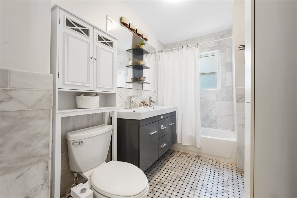 24 Jackson Road, Unit 2 Somerville, MA 02145 - Photo 21 of 35 a bathroom with a sink a toilet and shower