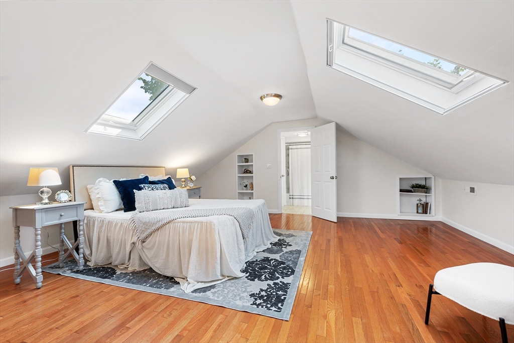 24 Jackson Road, Unit 2 Somerville, MA 02145 - Photo 22 of 35 a bedroom with a bed and wooden floor