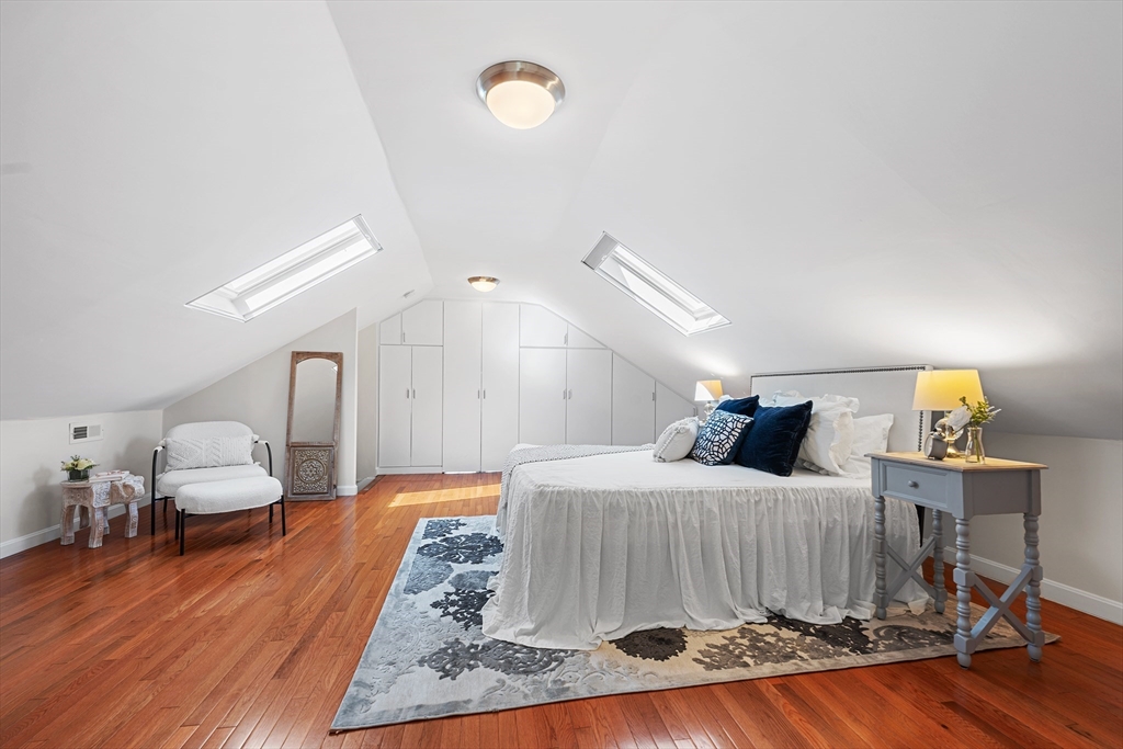 24 Jackson Road, Unit 2 Somerville, MA 02145 - Photo 24 of 35 a bedroom with a bed and wooden floor