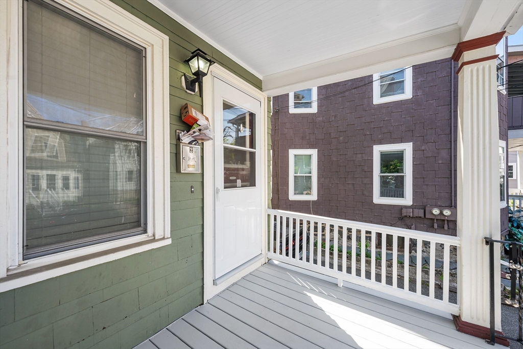 24 Jackson Road, Unit 2 Somerville, MA 02145 - Photo 31 of 35 a view of a brick house with a large window