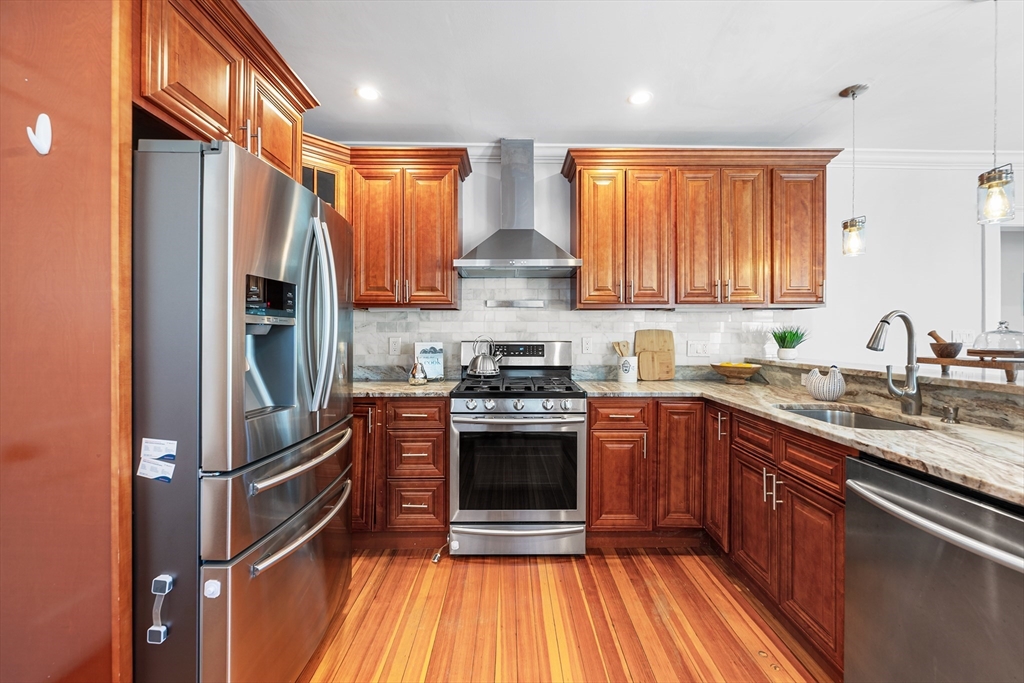 24 Jackson Road, Unit 2 Somerville, MA 02145 - Photo 7 of 35 a kitchen with stainless steel appliances granite countertop a stove and a refrigerator