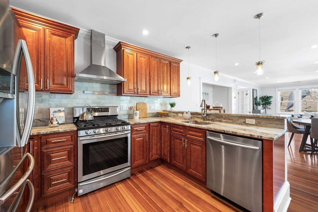 24 Jackson Road, Unit 2 Somerville, MA 02145 - Photo 9 of 35 a kitchen with stainless steel appliances granite countertop a stove a sink and a refrigerator