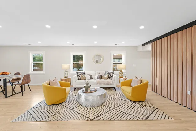 a living room with furniture a rug and a window