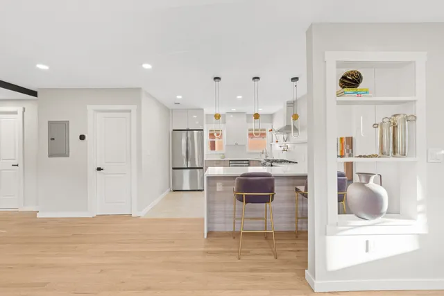 a view of kitchen with kitchen island stainless steel appliances refrigerator stove microwave and cabinets