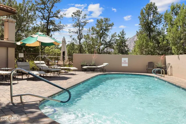 an aerial view of residential houses with outdoor space and seating
