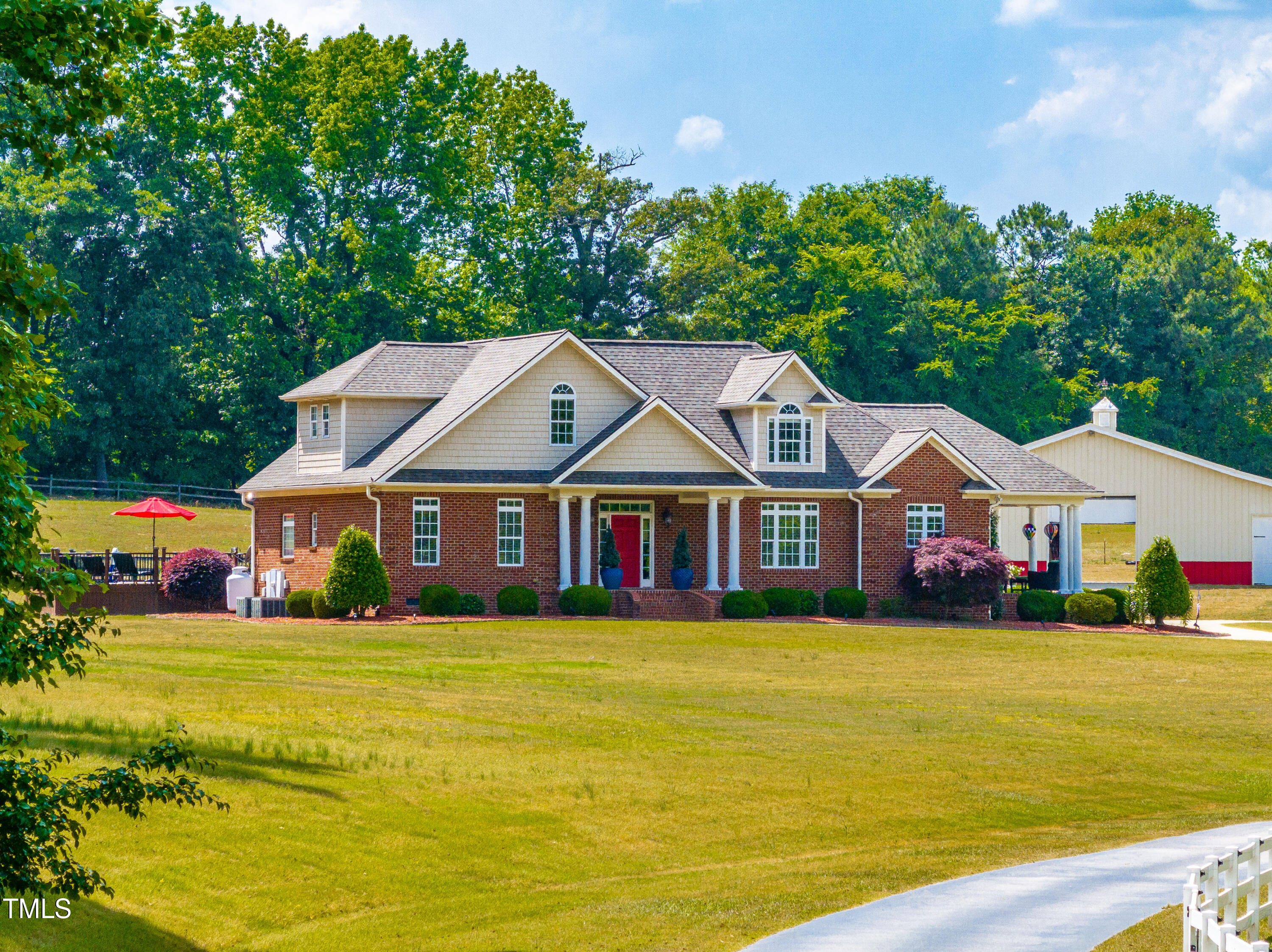 a view of a house next to a big yard