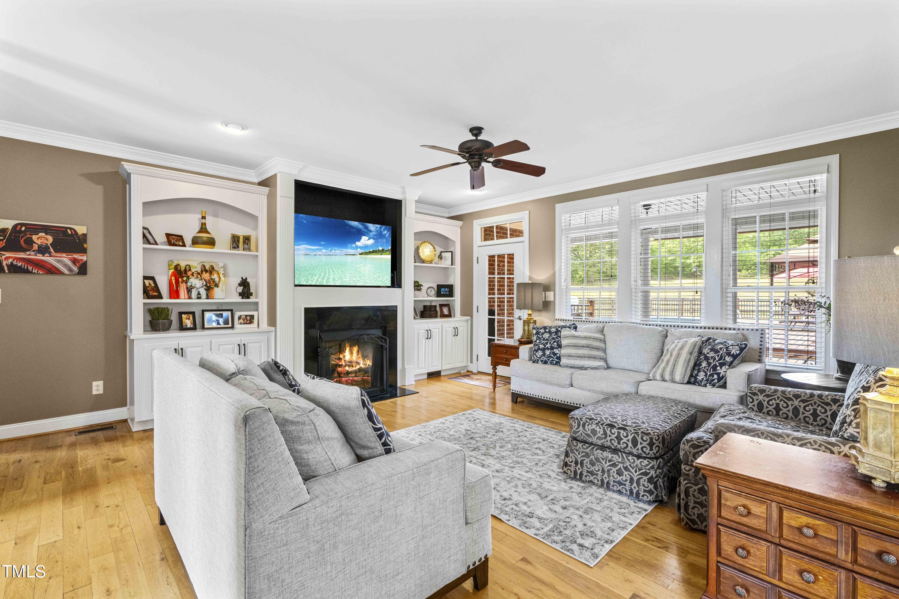 115 Three M Trail Benson, NC 27504 - Photo 13 of 80 a living room with furniture a flat screen tv and a fireplace