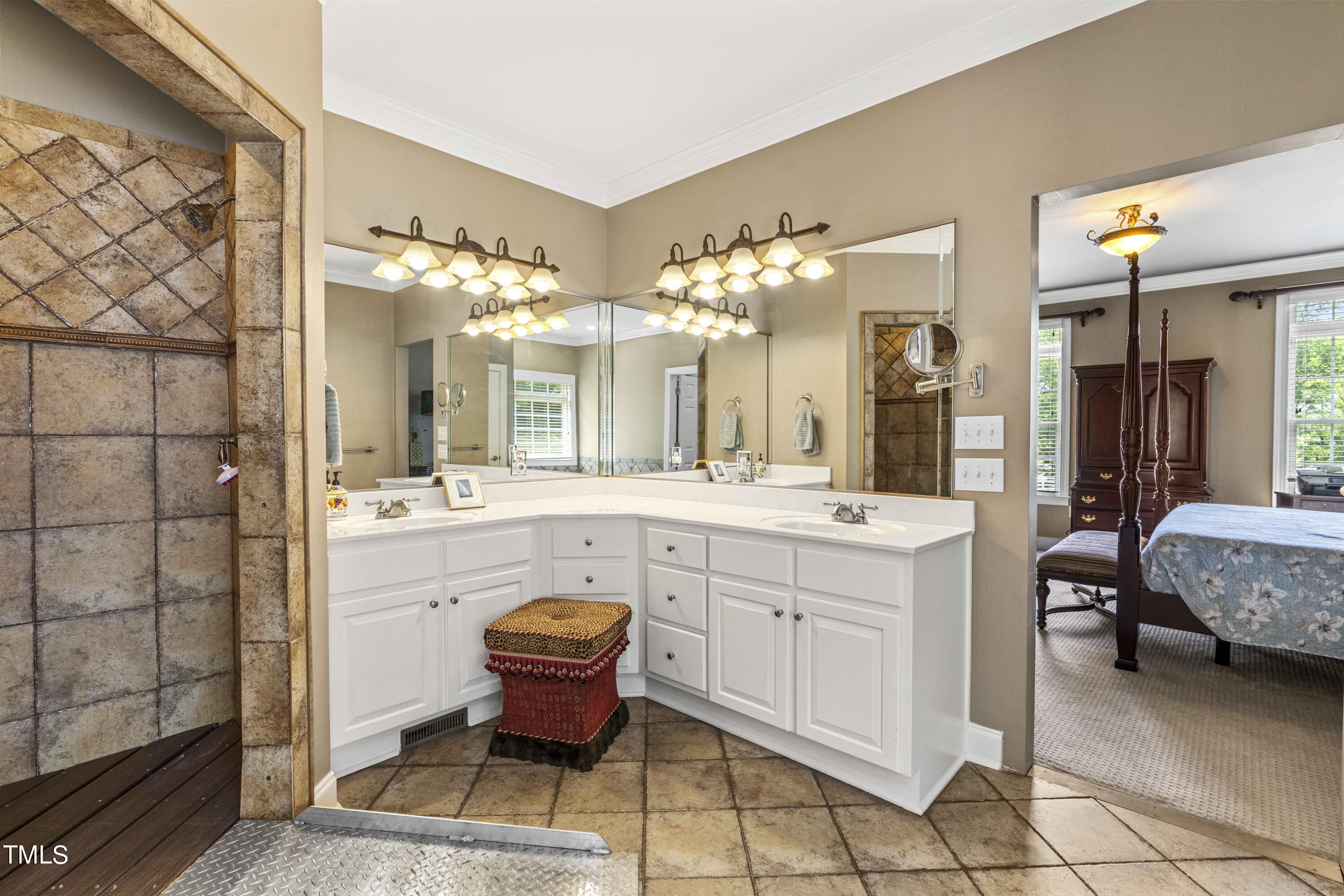 115 Three M Trail Benson, NC 27504 - Photo 28 of 80 a spacious bathroom with a double vanity sink a mirror and a bathtub