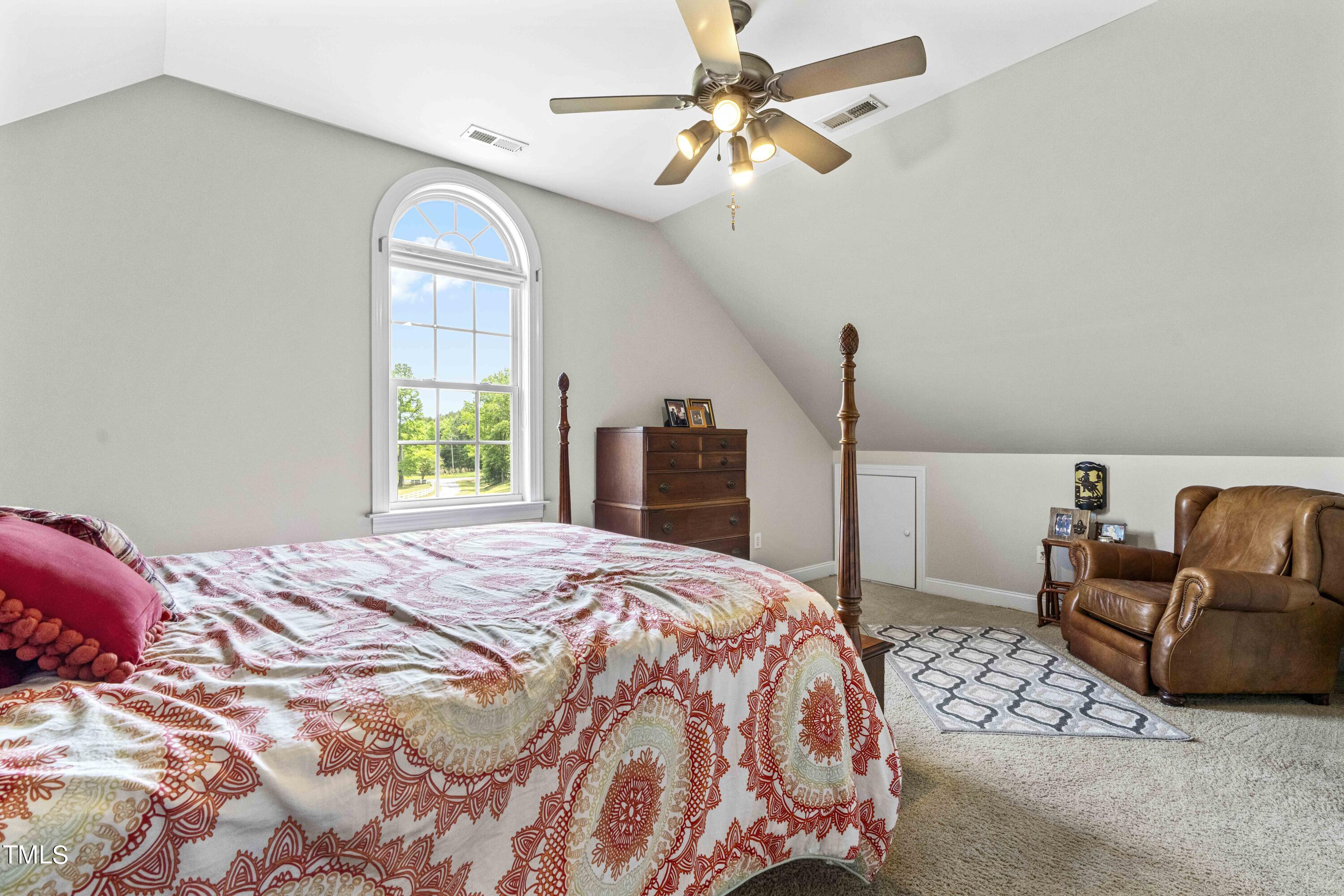 115 Three M Trail Benson, NC 27504 - Photo 31 of 80 a bedroom with a bed chandelier and a window
