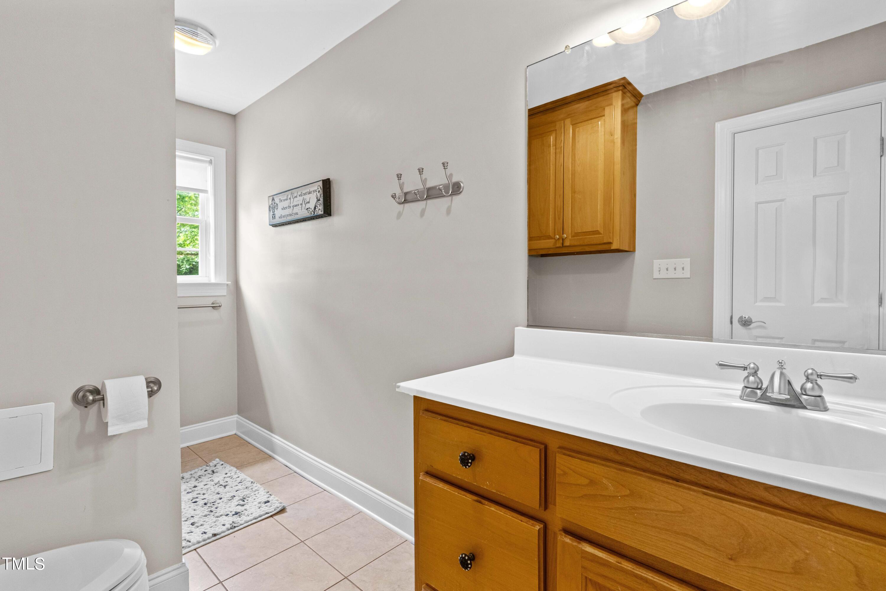 115 Three M Trail Benson, NC 27504 - Photo 32 of 80 a bathroom with a sink and a mirror