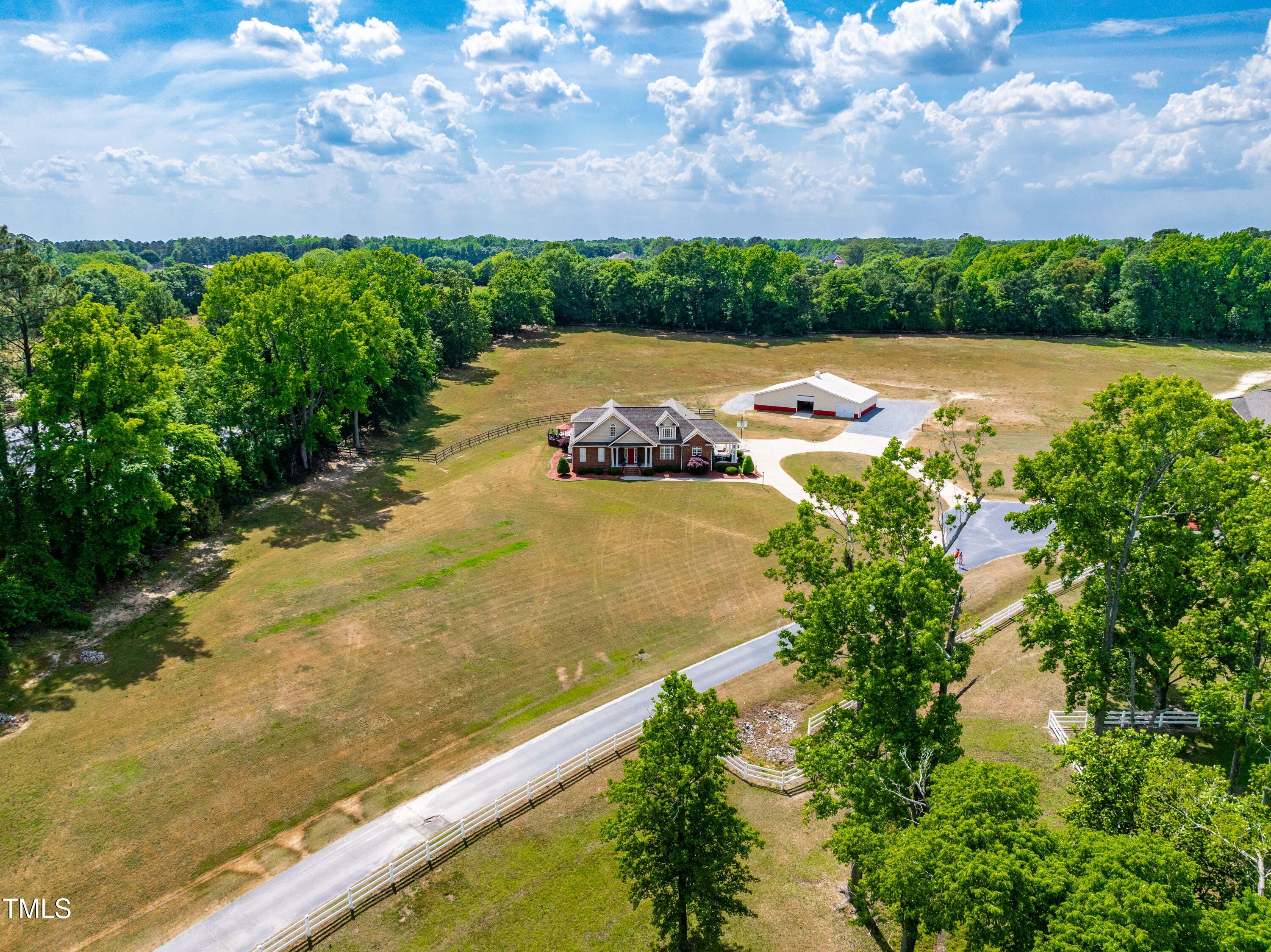 115 Three M Trail Benson, NC 27504 - Photo 56 of 80 an aerial view of a house with a garden and lake view