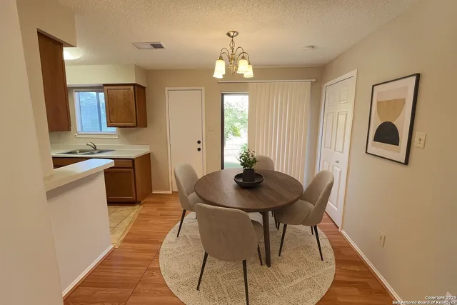 a view of a dining room with furniture and a chandelier