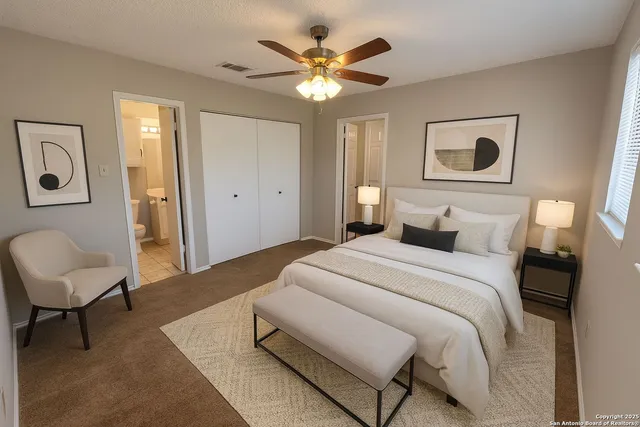 a bedroom with a large bed and a chair