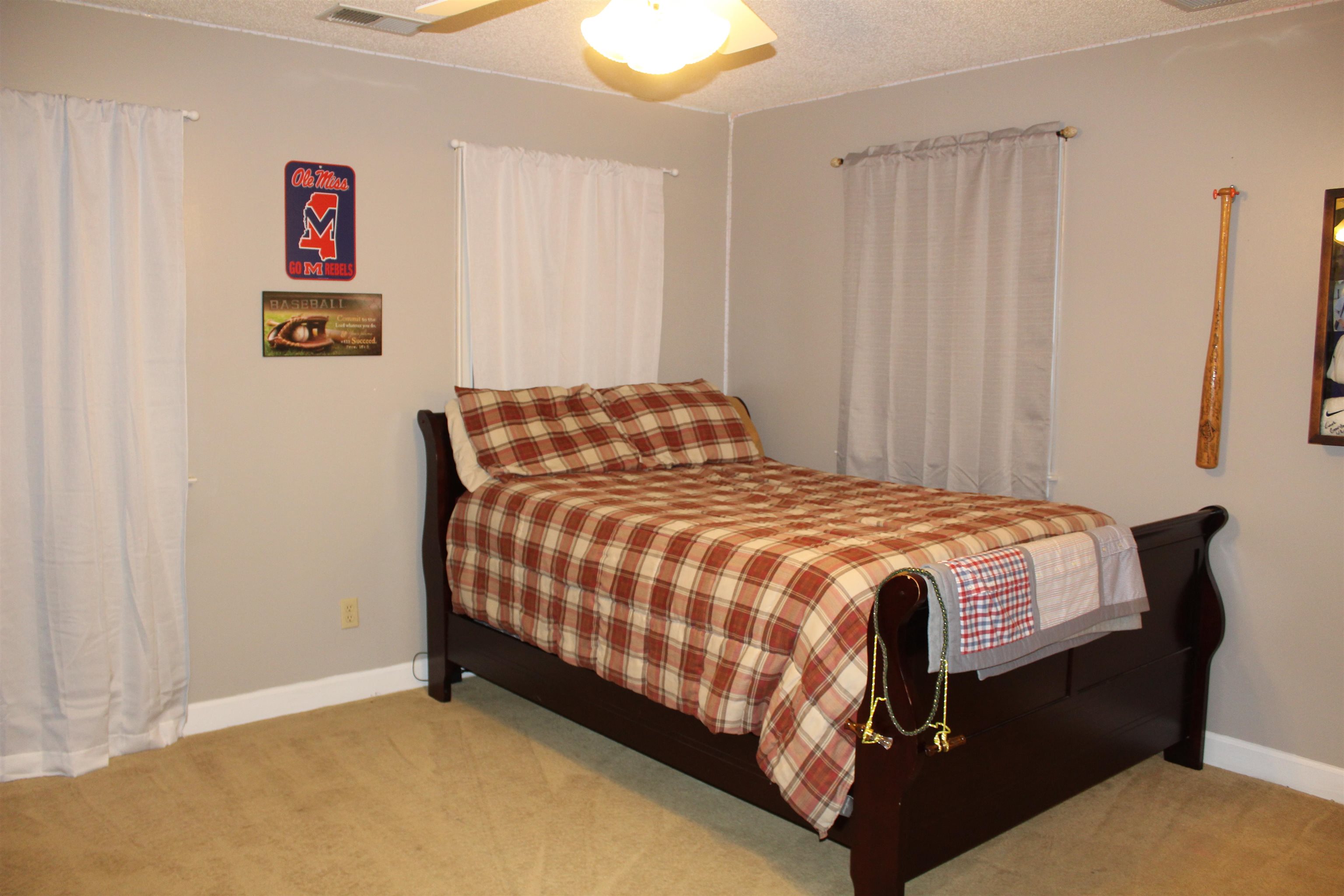 430 Belton Road Ripley, TN 38063 - Photo 18 of 25 a bed sitting in a bedroom next to a window