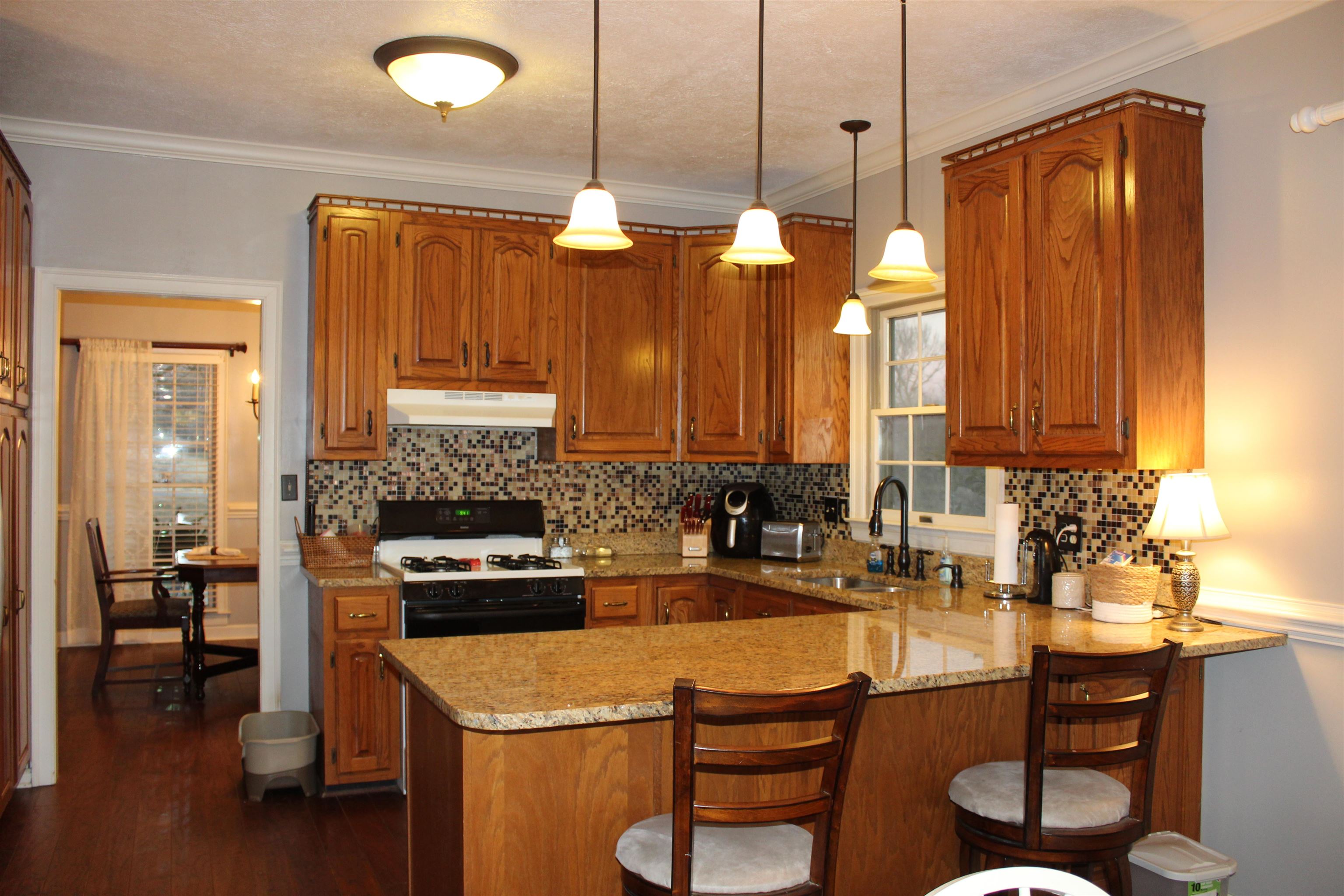 430 Belton Road Ripley, TN 38063 - Photo 10 of 25 a kitchen with a stove a sink and a refrigerator