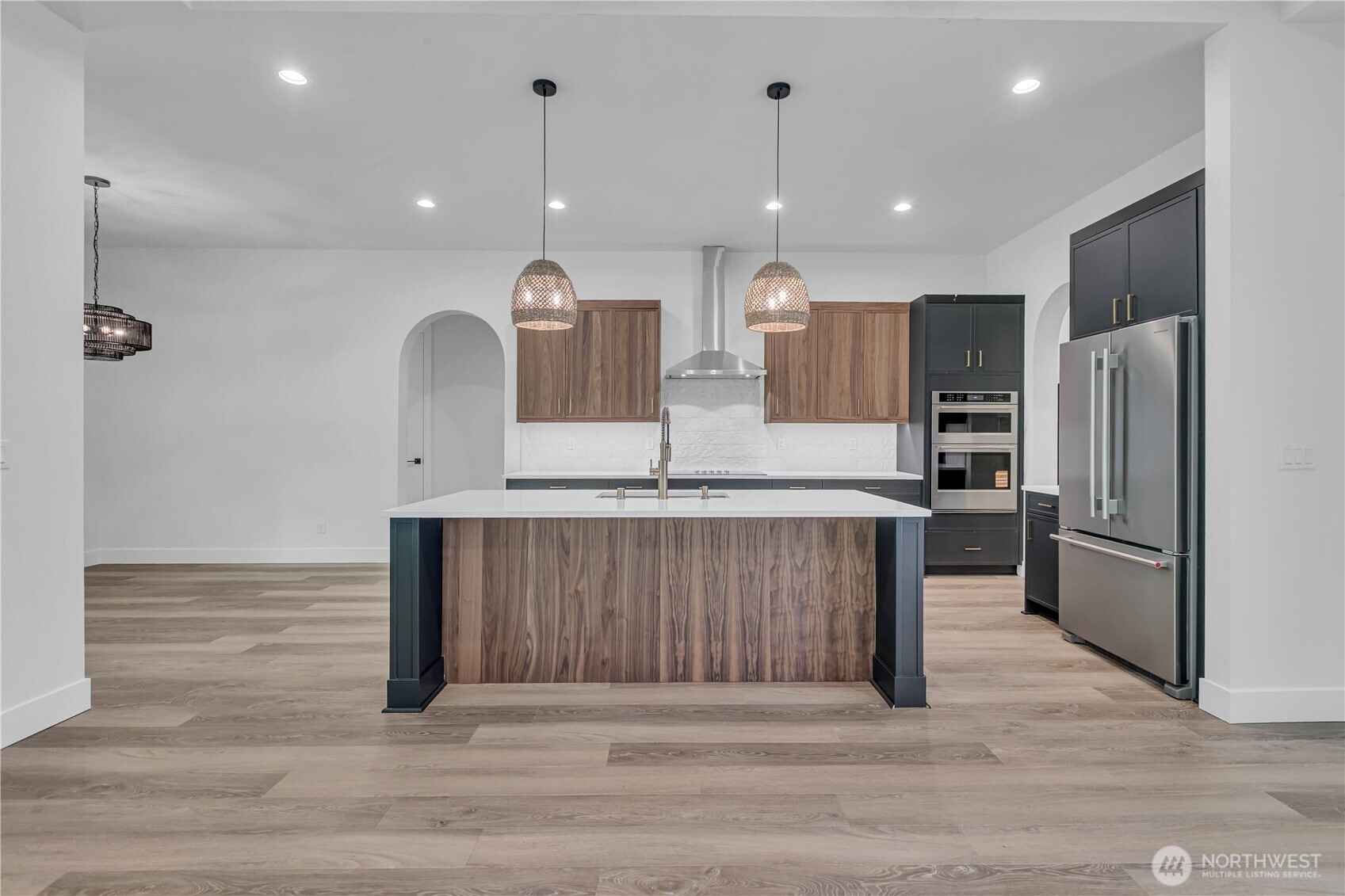6709 254th Street East Graham, WA 98338 - Photo 10 of 40 a kitchen with stainless steel appliances kitchen island granite countertop a refrigerator a sink and a oven