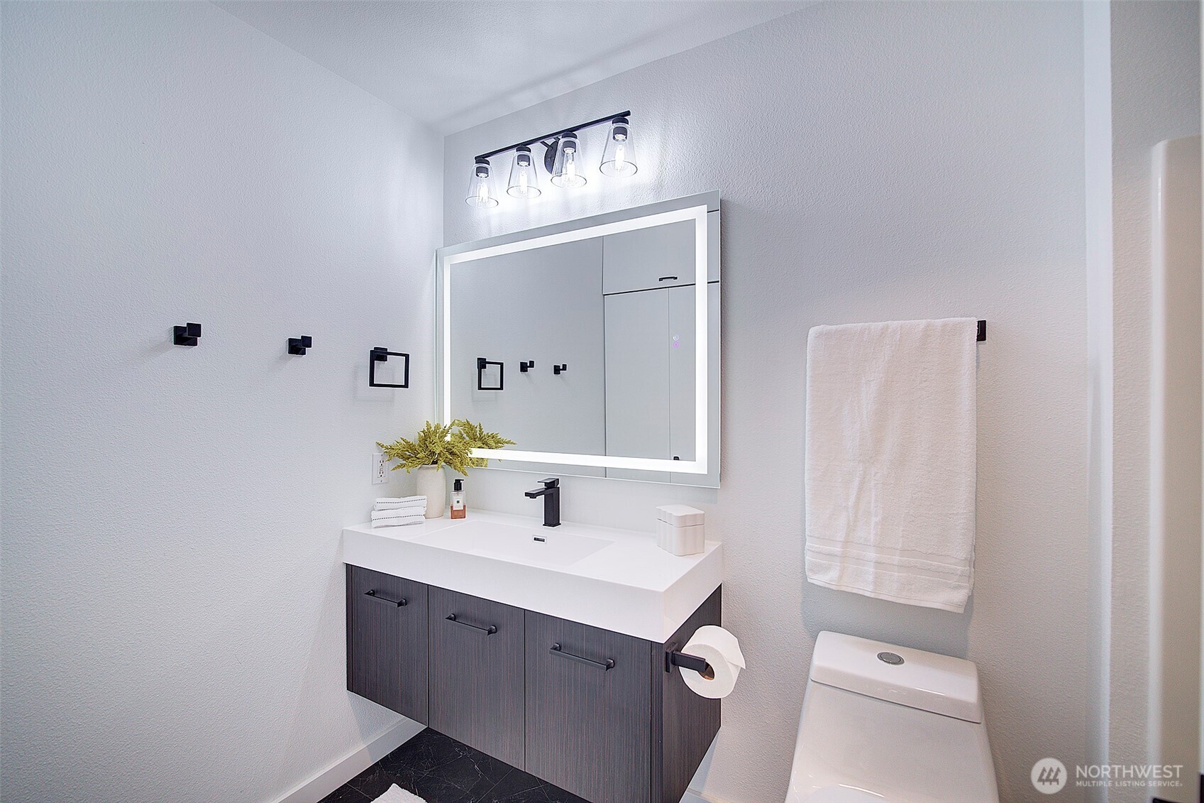303 23rd Avenue South, Unit 506 Seattle, WA 98144 - Photo 20 of 36 a bathroom with a sink vanity and a mirror