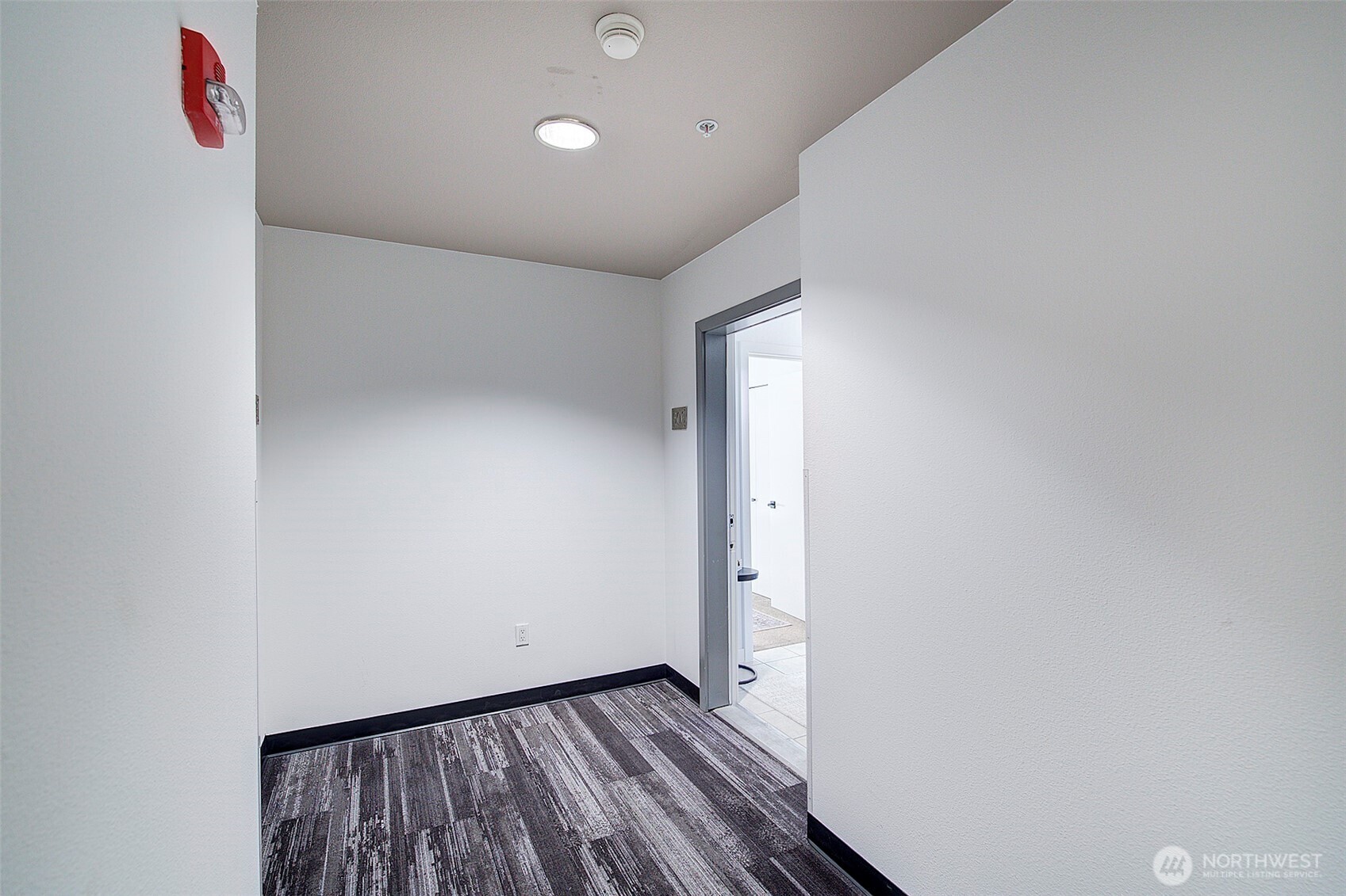 303 23rd Avenue South, Unit 506 Seattle, WA 98144 - Photo 24 of 36 a view of an empty room with wooden floor