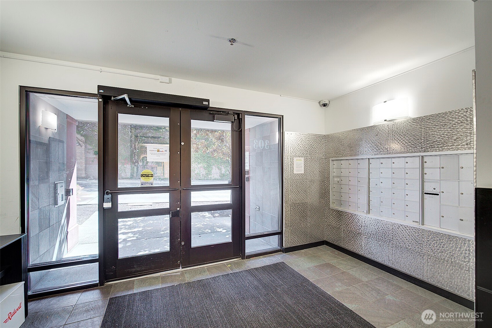 303 23rd Avenue South, Unit 506 Seattle, WA 98144 - Photo 29 of 36 a view of an empty room with glass door and windows