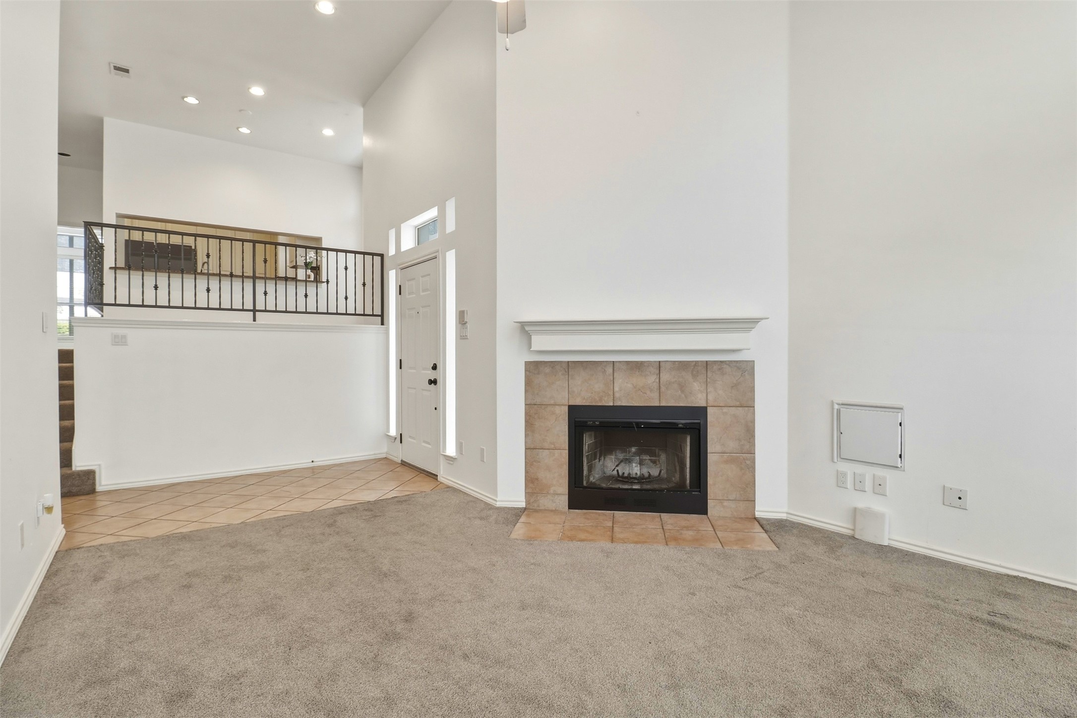 2918 Ranch Road 620, Unit 265 Austin, TX 78734 - Photo 8 of 40 A spacious living area featuring a cozy fireplace and high ceilings.