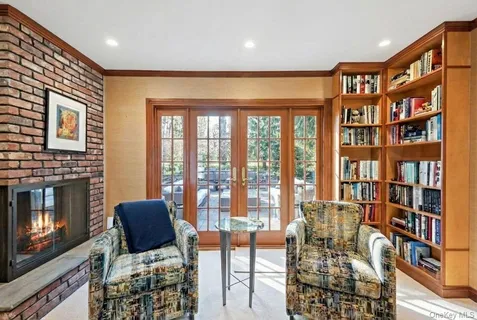 a living room with furniture fireplace and book shelf