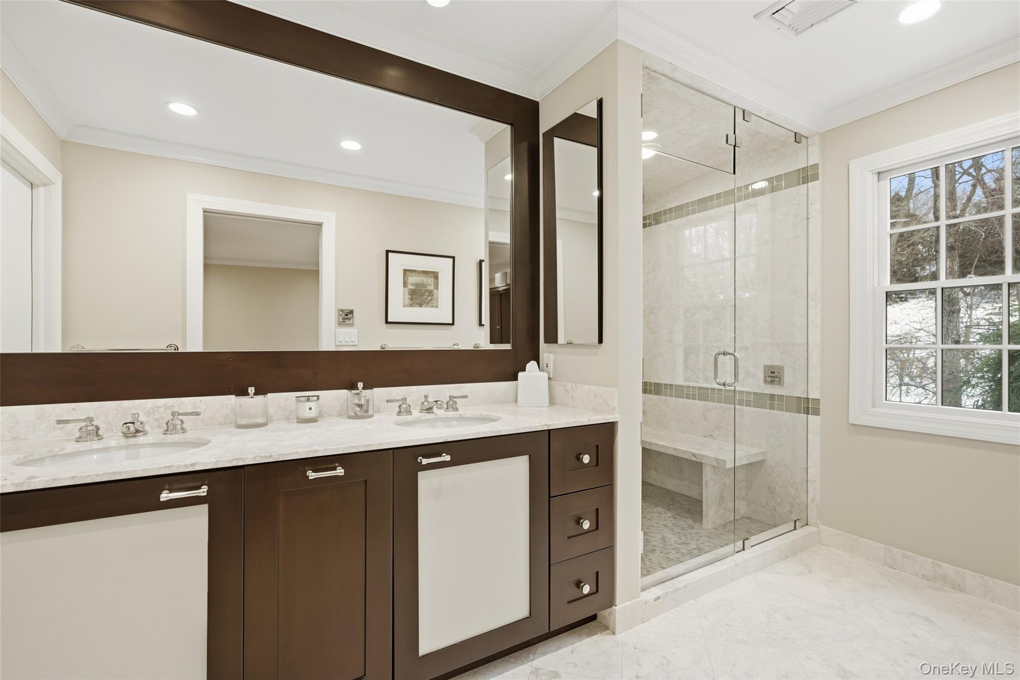 10 Oriole Place Rye Brook, NY 10573 - Photo 21 of 40 a bathroom with a sink a large mirror and a shower