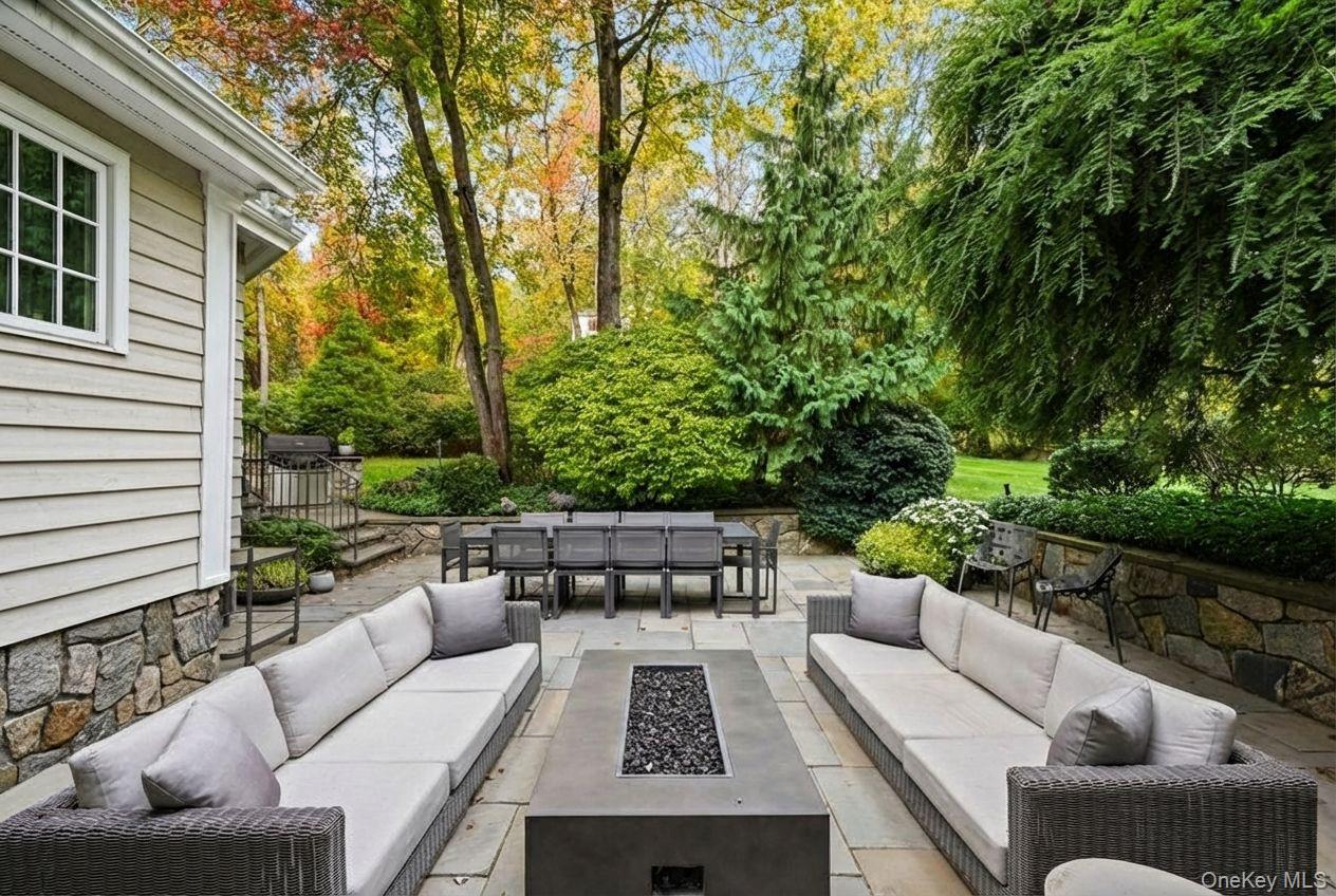 10 Oriole Place Rye Brook, NY 10573 - Photo 31 of 40 a view of a patio with couches and a table and chairs with wooden fence and plants