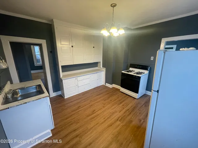 a bedroom with a bed and a flat tv screen on dresser