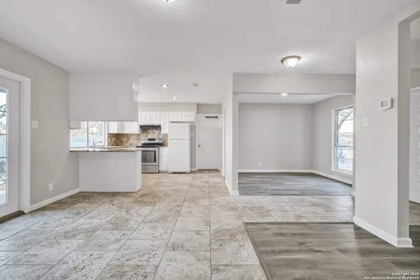 a view of kitchen with refrigerator and window