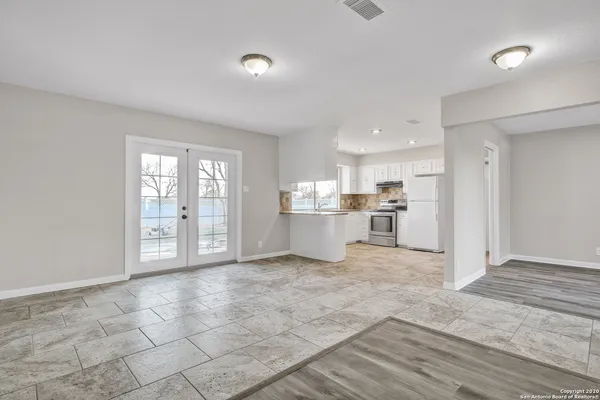 a view of a kitchen with wooden floor and windows